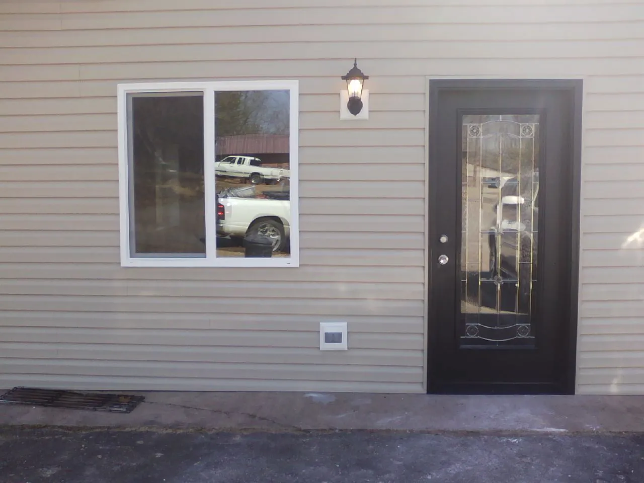 New siding, window and entry door on the side of an addition in Mount Hope